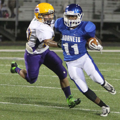 Diante Woodson evades a Catholic defender. (Photo by Rick Nation)