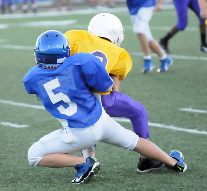 Cameron Scarlett makes a tackle after a Horace Mann pass completion. (Photo by Kevin Nagle)