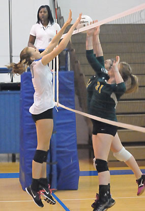 Emily Clem goes up for a block. (Photo by Kevin Nagle)