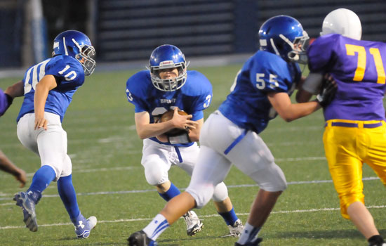 Alex Wright (33) takes a handoff from Jesse Windemaker (10) and follows the block of Jakob Neel (55) on the way to one of his two touchdown runs. (Photo by Kevin Nagle)