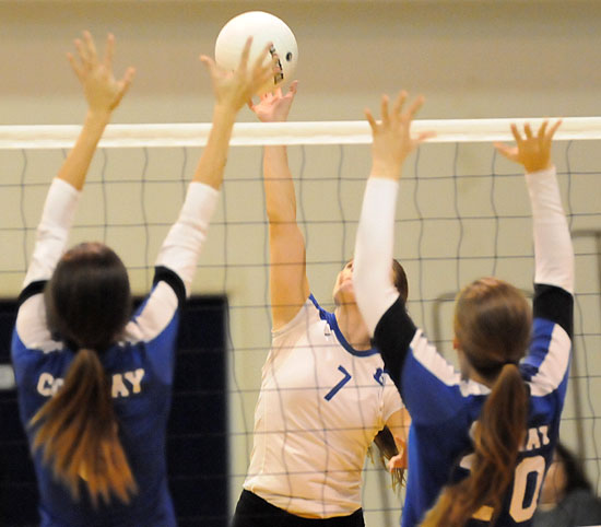 Mercedes Dillard (7) tries to  squeeze a hit between a pair of Conway blockers. (Photo by Kevin Nagle)