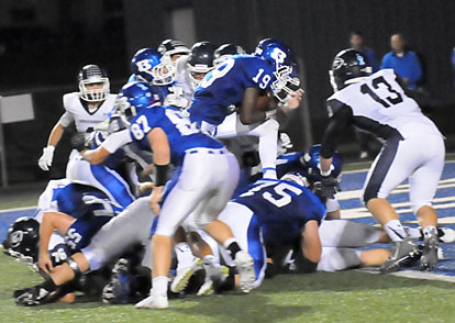 Kylon Boyle steps into the end zone over the pile at the line of scrimmage. (Photo by Kevin Nagle)