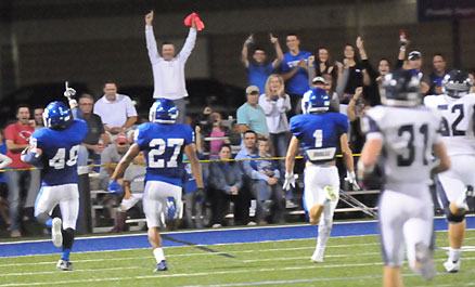 Fans join Connor Chapdelaine celebrate his 92-yard interception return for a touchdown. (PHoto by Kevin Nagle)