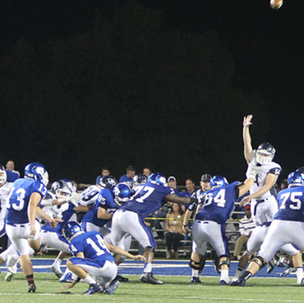 Alex Denker (31) kicked a key 28-yard field goal out of the hold of Madison Schrader (14) in Friday's game. (Photo by Rick Nation)