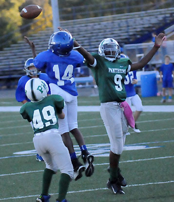 Arlon Jenkins (14) hauls in a pass that he turned into a touchdown over Pulaski Heights' Jack Meyer (48) and Nakiyah Davis. (Photo by Kevin Nagle)