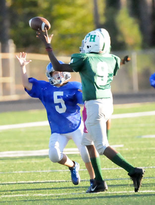 Bryant White's Cameron Scarlett (5) pressures Pulaski Heights quarterback Nakiyah Davis (9). (Photo by Kevin Nagle)