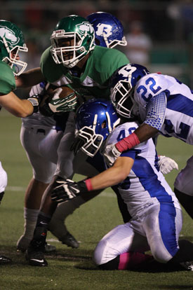 Phillip Isom-Green (22) and Connor Chapdelaine (48) join a teammate to stop Van Buren's Jaclyn Dye. (Photo by Rick Nation)