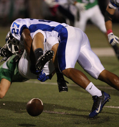 Steven Murdock drills Van Buren receiver Tyler Morton. (Photo by Rick Nation)