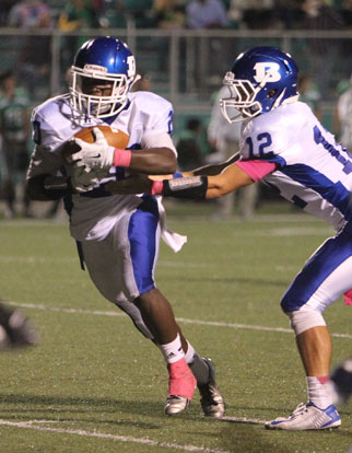 Quarterback Brandan Warner (12) hands off to running back DeAmonte Terry. (Photo by Rick Nation)