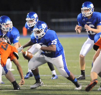 Jaret Jacobs (16) awaits a snap as the offensive linemen including Larae Williams (76) fires off the ball. (Photo by Kevin Nagle)