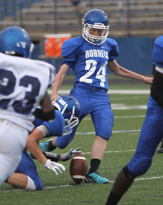 Luke Welch (24) kicks an extra point. (Photo by Rick Nation)