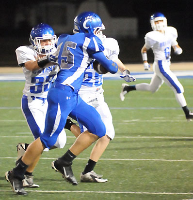 Brooks Ellis (33) and Luke Curtis converge on Conway White quarterback Andrew Hreha. (Photo by Kevin Nagle)