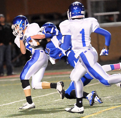 Cameron Vail (5) tries to break a tackle after hauling in a pass as Jakalon Pittman (1) rushes down the field to block. (Photo by Kevin Nagle)