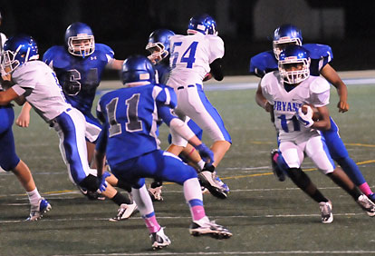 Diante Woodson turns the corner off a block by Zak Kemp (54). (Photo by Kevin Nagle)