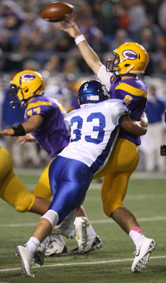 Hunter Fugitt (33) pressures Catholic quarterback Andre Sale. (Photo by Rick Nation)