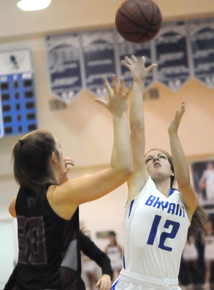 Maddie Baxter (12) lofts a shot up over a Benton defender. (Photo by Kevin Nagle)