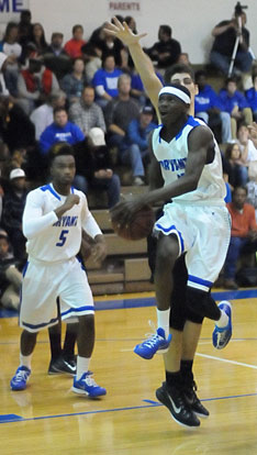 Kevin Hunt (11) drives to the basket as Antivirus Lewis (5) moves in for rebounding position. (Photo by Kevin Nagle)