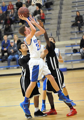 Luke Curtis (25) puts up a shot in a crowd. (Photo by Kevin Nagle)