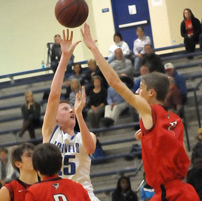 Luke Curtis (25) gets a shot over a Russellville defender. (Photo by Kevin Nagle)