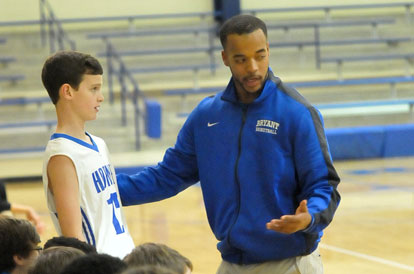 Bethel coach Dominic Lincoln talks with one of his players before putting him in the game. (Photo by Kevin Nagle)