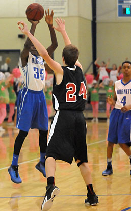 Randy Thomas (35) fires a 3-pointer over Russellville's Bryson Kordsmeier during Monday's game. Josh Robertson is number 4. (Photo by Kevin Nagle)