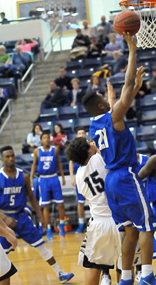 Romen Martin (21) goes up for a shot over Greenwood's Grant Morgan (15) as teammate Antivirus Lewis follows up on the play. (Photo by Kevin Nagle)