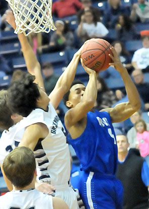 Wesley Peters muscles up a shot despite Greenwood's defense. (Photo by Kevin Nagle)