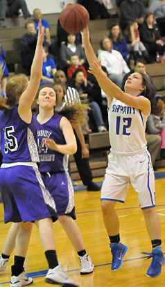 Bryant's Maddie Baxter (12) shoots over Mount St. Mary defenders Lizzie Allgood (35) and Allie Walls (14). (Photo by Kevin Nagle)