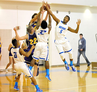 Antavious Lewis (5) and Lowell Washington (32) contend for a rebound with William Hancock (22) and Trey Purifoy. (Photo by Kevin Nagle)