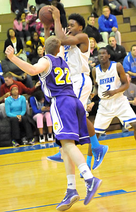 Lowell Washington appears to get poked in the mouth as he rebounds in front of teammate Kaleb Turner (2). (Photo by Kevin Nagle)