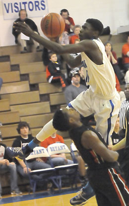 Kevin Hunt tries to evade a defender on as he goes up for a shot. (Photo by Kevin Nagle)