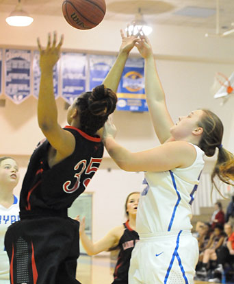 Anna Turpin, right, tries to get a shot over Russellville's Maliyah Franklin. (Photo by Kevin Nagle)