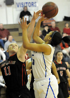 Emily Ridgell takes a shot as Russellville's Addy Hipps (11) defends. (Photo by Kevin Nagle)