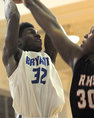 Lowell Washington (32) tries to get a shot over Russellville's Kris Patrick. (Photo by Kevin Nagle)