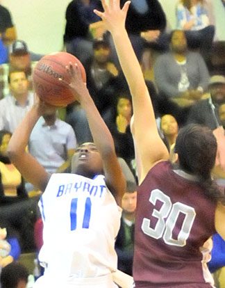 Lauren Carroll (11) gets past Siloam Springs' Mirna Torres for a shot. (Photo by Kevin Nagle)