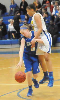 Maddie Miller (5) tries to retain possession of the ball as she's clobbered by a North Little Rock defender. (Photo by Kevin Nagle)