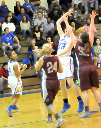 Rachel Miller gets a shot away in traffic as Destiny Martin (2) looks on. (Photo by Kevin Nagle)