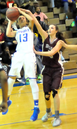 Raija Todd (13) gets a shot away despite being fouled. (Photo by Kevin Nagle)