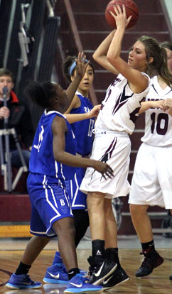 Lauren Carroll and Raija Todd try to trap Benton's Braxton Chumley. (Photo by Rick Nation)