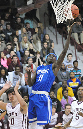 Kevin Hunt (11) goes up for a hoop over Cason Maertens (10). (Photo by Rick Nation)