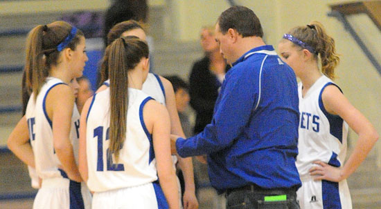 Bethel coach Derek McGrew meets with his team during a timeout. (Photo by Kevin Nagle)