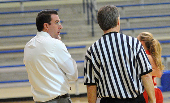 Bryant coach Nathan Castaldi discusses a call with one of the officials in Thursday night's game. (Photo by Kevin Nagle)