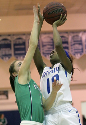 Bryant's Jakeira Otey (10) tries to get a shot up over Van Buren's Kaylee Sheppard. (Photo by Rick Nation)