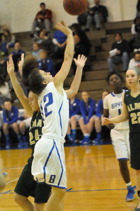 Maddie Baxter (12) gets a shot away around Alma's Cierra Rainwater. (Photo by Kevin Nagle)