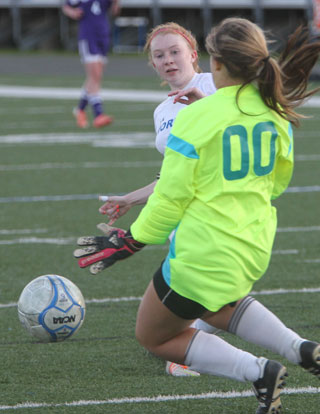 Caroline Campbell attacks the goal and the keeper (00). (File photo by Rick Nation)