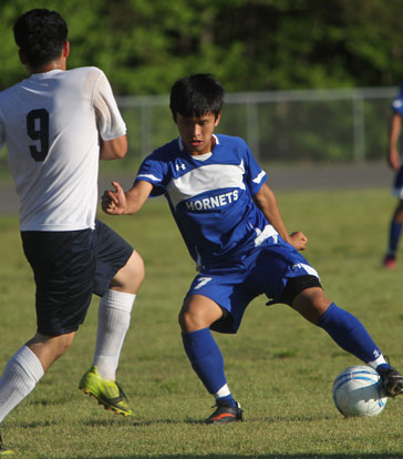 Krishna Gurung (7) tries to maneuver around a defender. (File photo by Rick Nation)