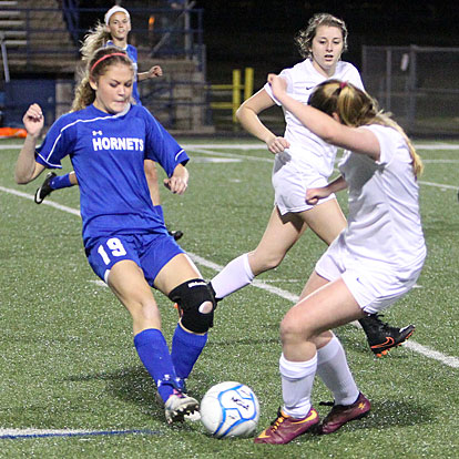 Bryant's Natalie Pierce (19) battles for possession of the ball. (Photo by Rick Nation)