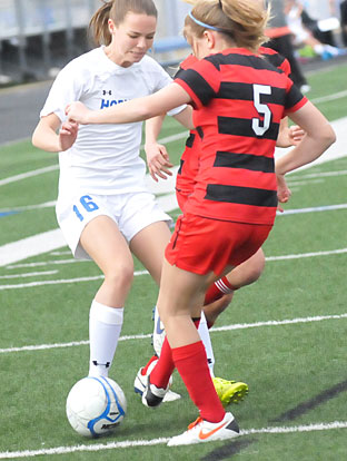 Jessica Butler (16) battles a Cabot player for possession. (Photo by Kevin Nagle)