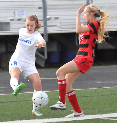 Ashlie Sparks (18) gets the ball past a Cabot player. (Photo by Kevin Nagle)