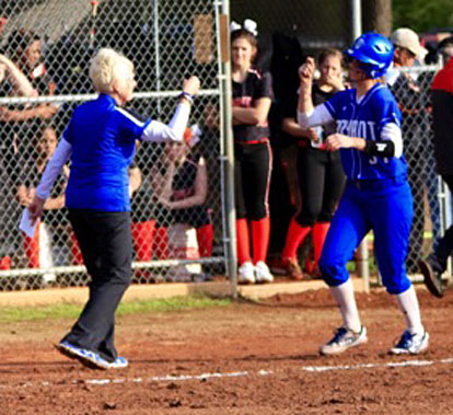Lady Hornets coach Debbie Clark congratulates Cayla McDowell after her home run. (Photo courtesy of Jon Staton)